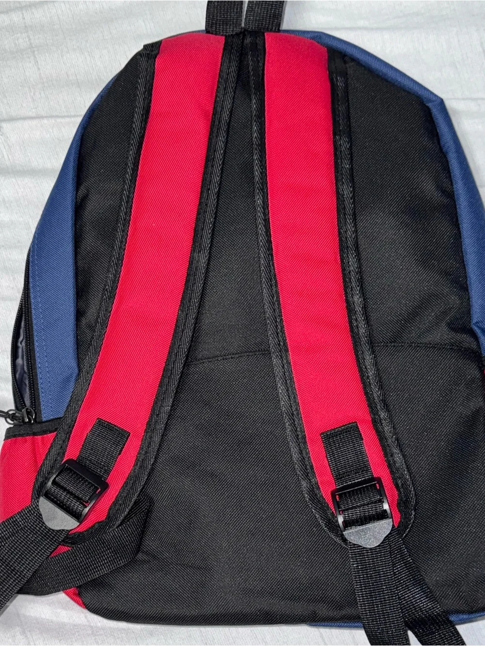 DePaul University navy blue and red backpack with white 'DEPAUL’ embroidered in